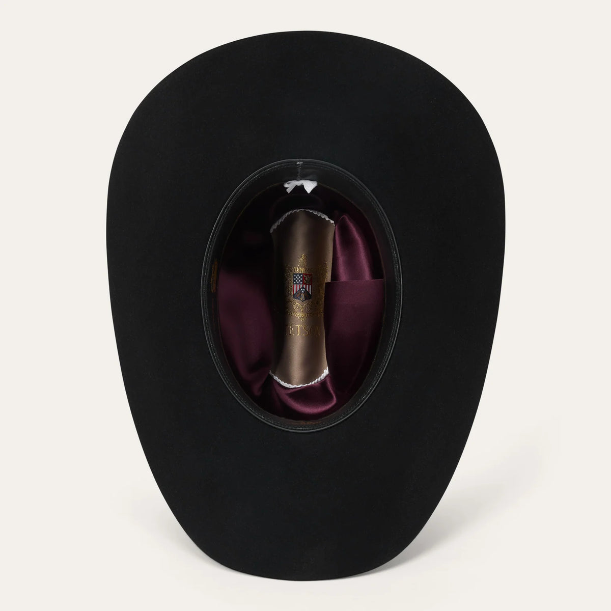 Interior view of the Stetson Rancher 30X cowboy hat displaying the premier roan leather sweatband and wine-red deluxe satin crown liner.