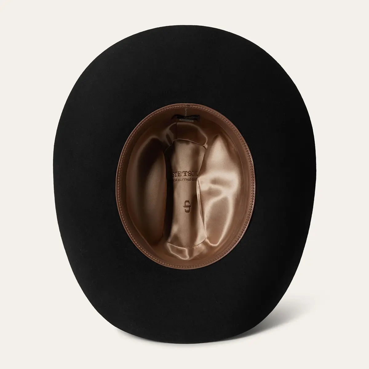 Underside view of the Stetson Corral 4X black felt cowboy hat displaying the interior bronze satin lining with Stetson American Buffalo branding and leather sweatband.