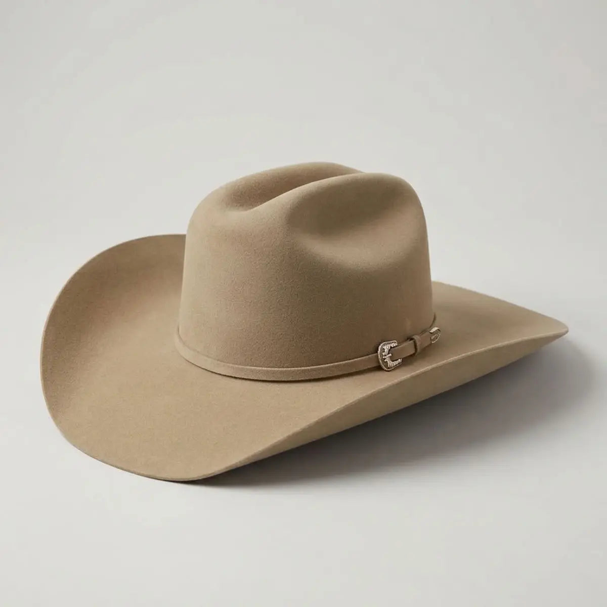 Three-quarter studio profile view of the Stetson 6X Skyline fawn fur felt cowboy hat showcasing the Cattleman crown, 4-inch brim, and silver buckle set.