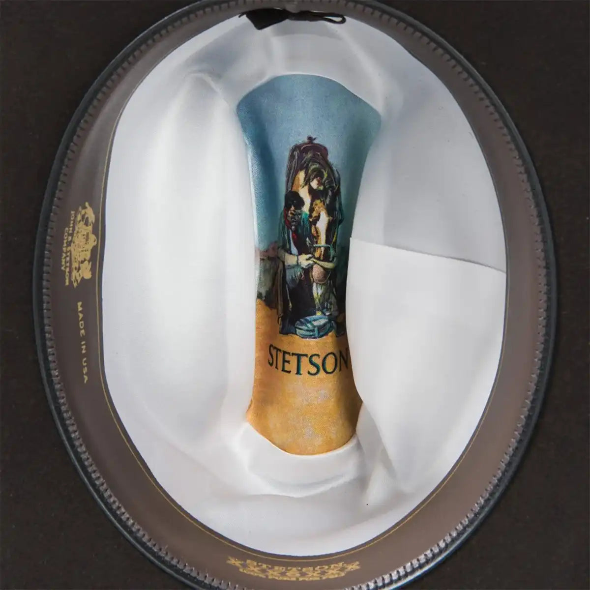 Interior view of the Stetson 6X Skyline hat showing the white satin liner with printed artwork, gold lettering, and handsewn leather sweatband.