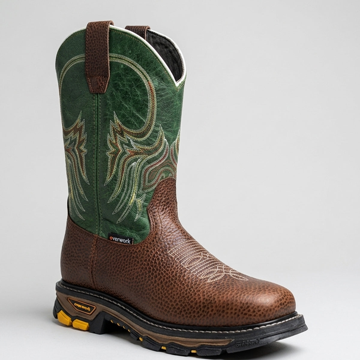 Overwork men's pull-on western work boots in pebble-grained brown leather featuring a distressed green shaft with multi-row embroidery and a square toe.