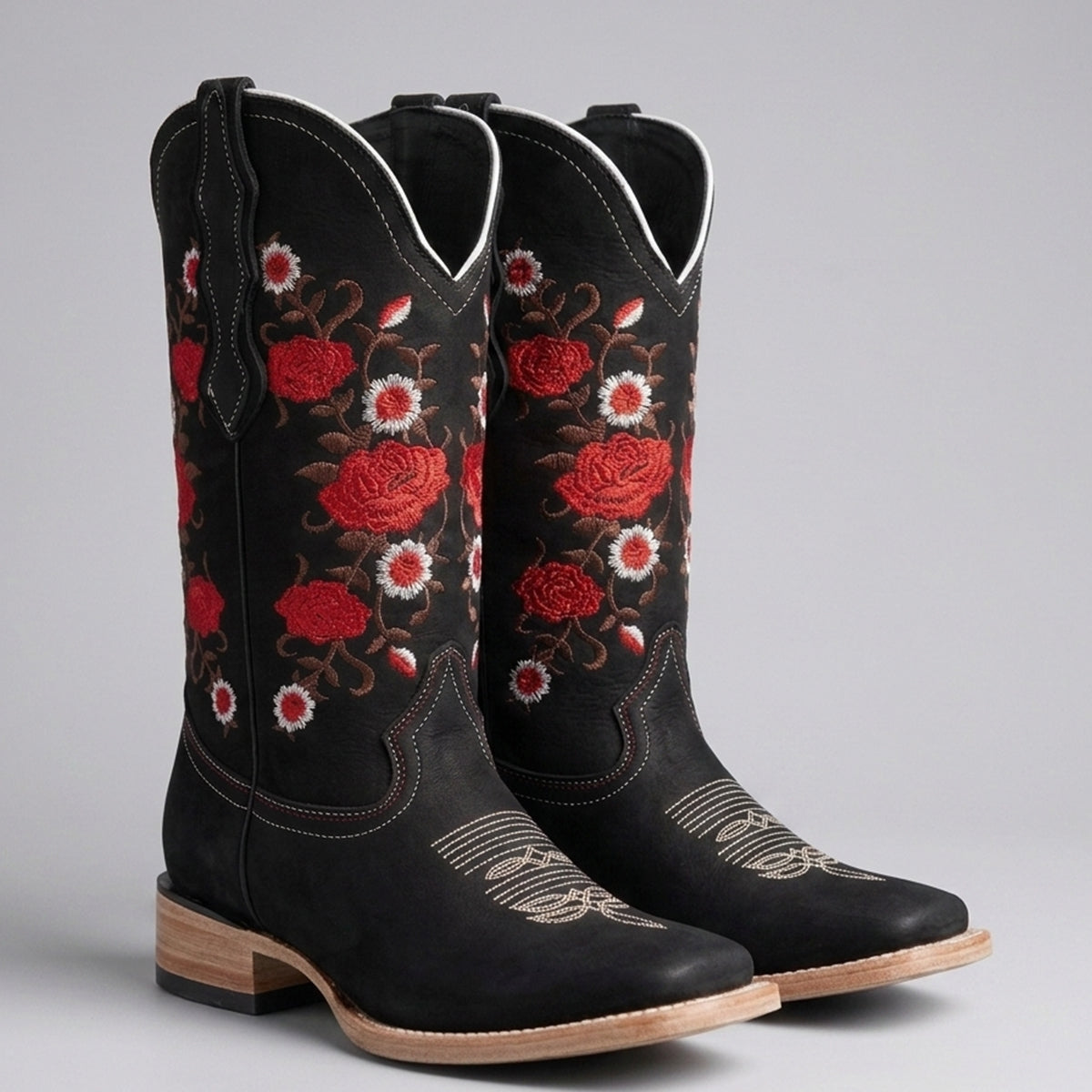 Women's black leather square toe cowgirl boots featuring detailed red and white embroidered roses with floral vines on the shaft.
