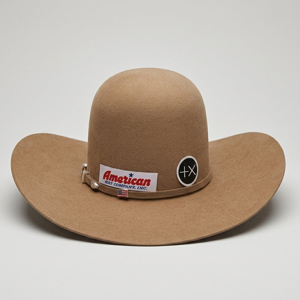 American Hat Company 7X Tuscan brown cowboy hat with visible stickers on a light gray background.