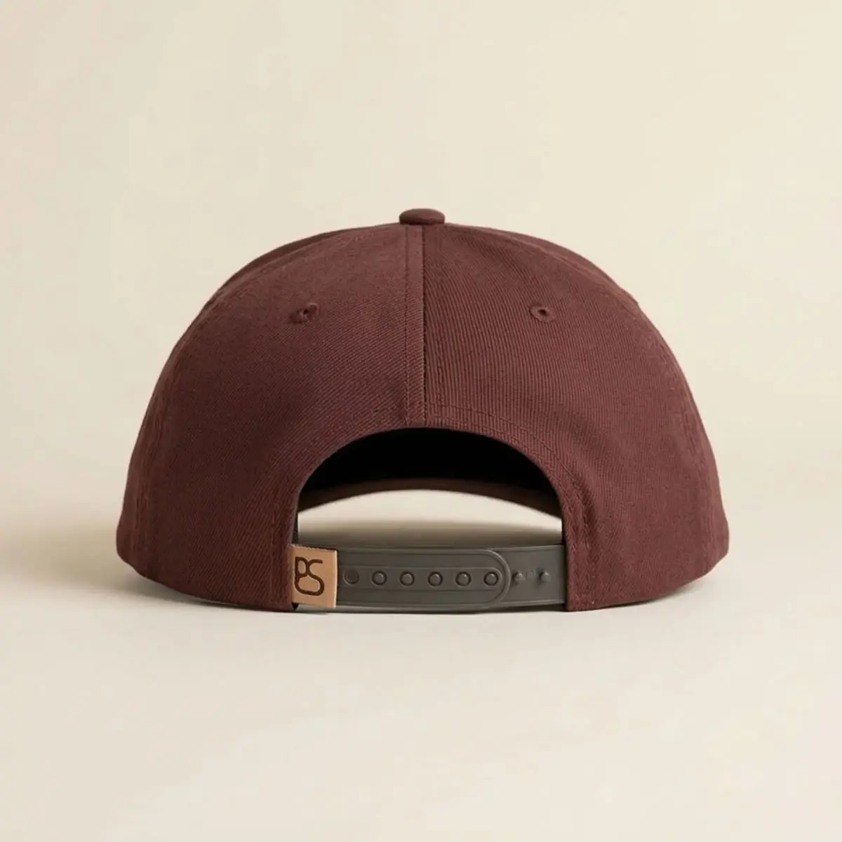 Back view of the Panhandle Slim maroon cap showing the matching solid twill panels and plastic snapback closure with the PS logo label.