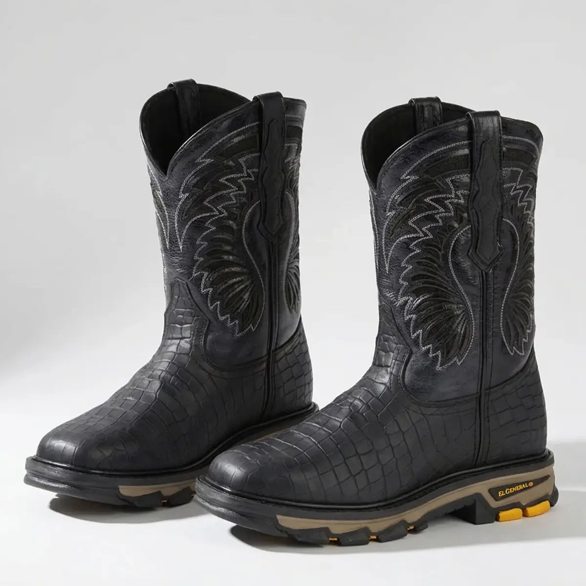 Pair studio view of the El General men's black caiman print square toe work boots displaying the embossed leather foot, tractor rubber outsole, and embroidered upper shaft.