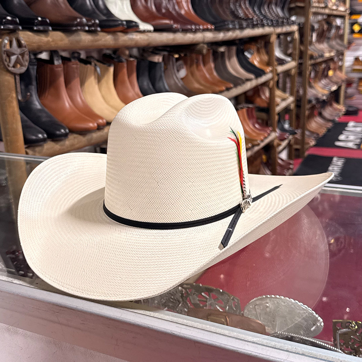 Cuernos Chuecos 100x Gorge straw western hat with feather and ribbon band.