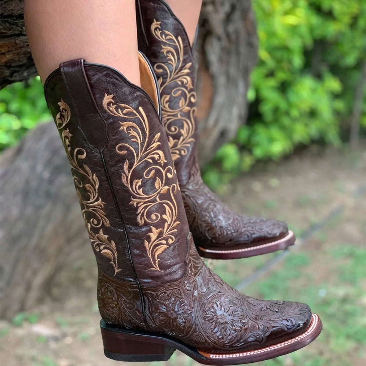 Botas Doble R women's dark brown floral tooled print cowgirl boots featuring intricate golden Western stitching on the shaft and a square toe.