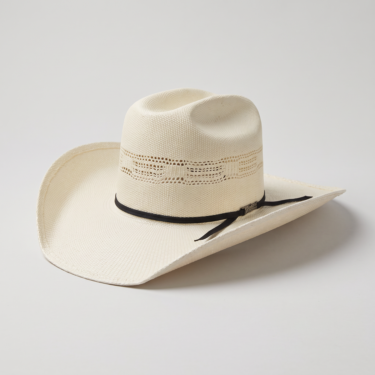 Three-quarter studio profile view of the American Hat Co. 657 Bangora straw cowboy hat on a neutral background showing the 4-inch JB brim and Cattleman crown crease.