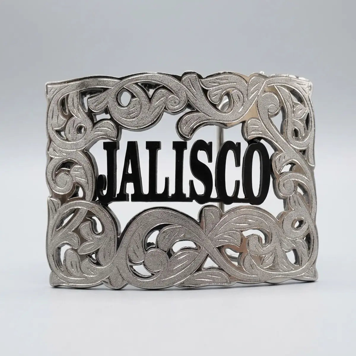 Studio front view of the Jalisco silver filigree belt buckle with black lettering displayed on a plain neutral background.