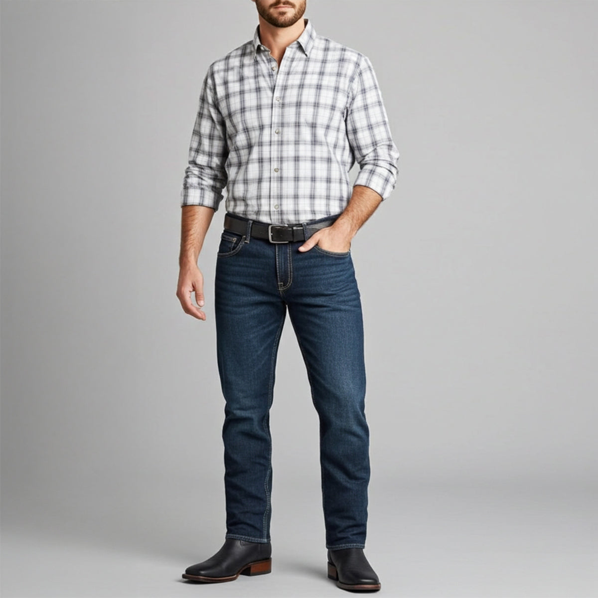 Man wearing black square toe boots with plaid western shirt