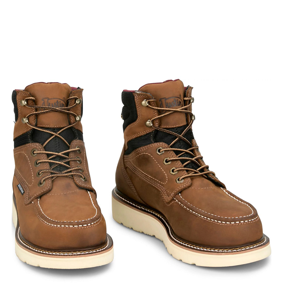 Pair of Justin men's brown leather steel toe work boots with black accents on a white background.
