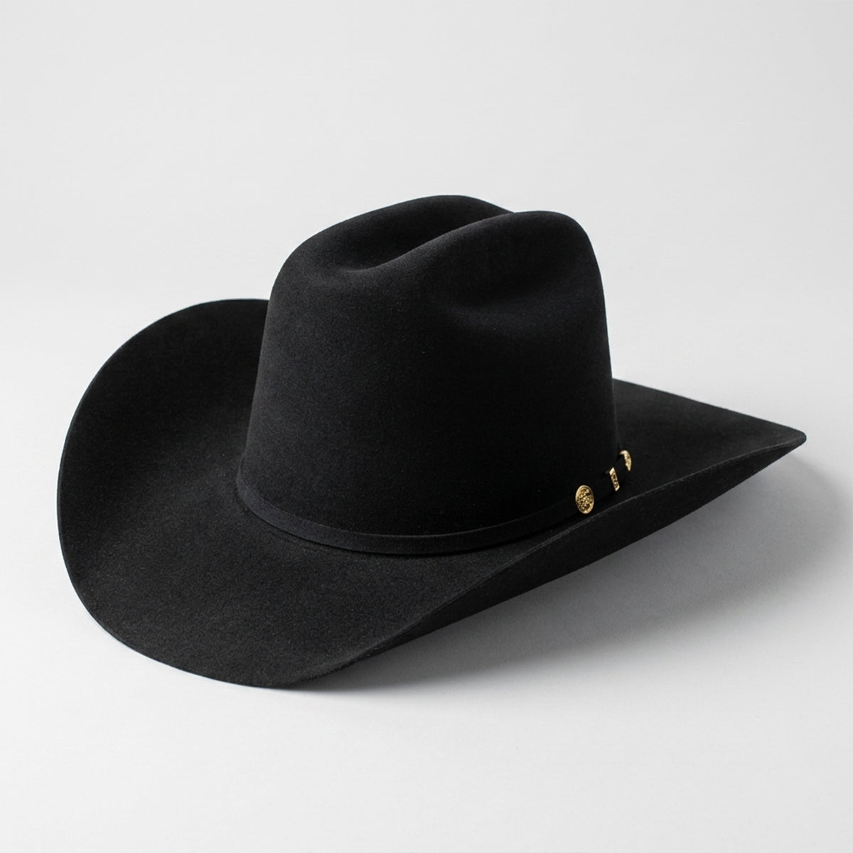 Stetson 100x El Presidente black felt cowboy hat with gold buckle on a light gray background.