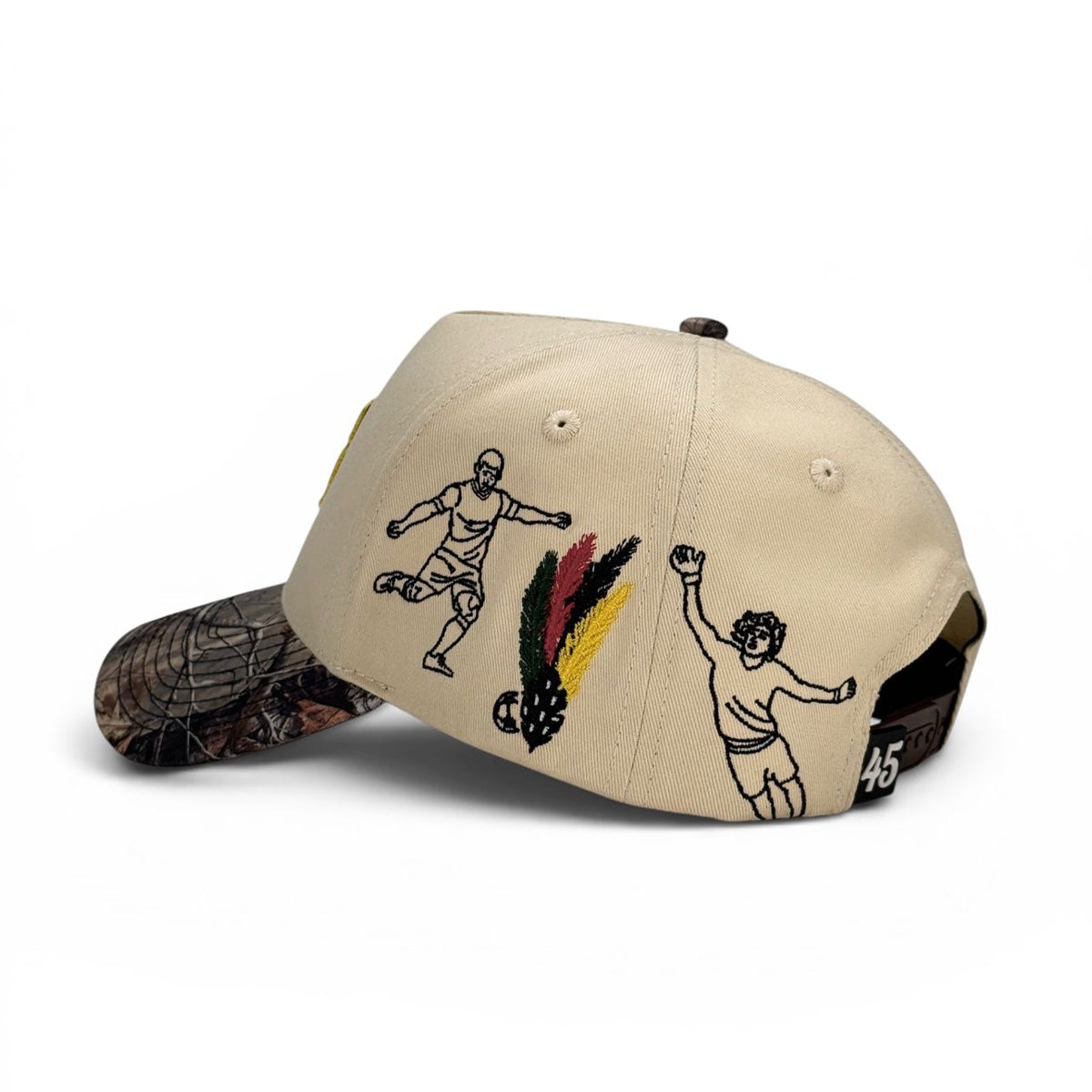 Mexico beige cap with black soccer and feather illustrations on a white background.