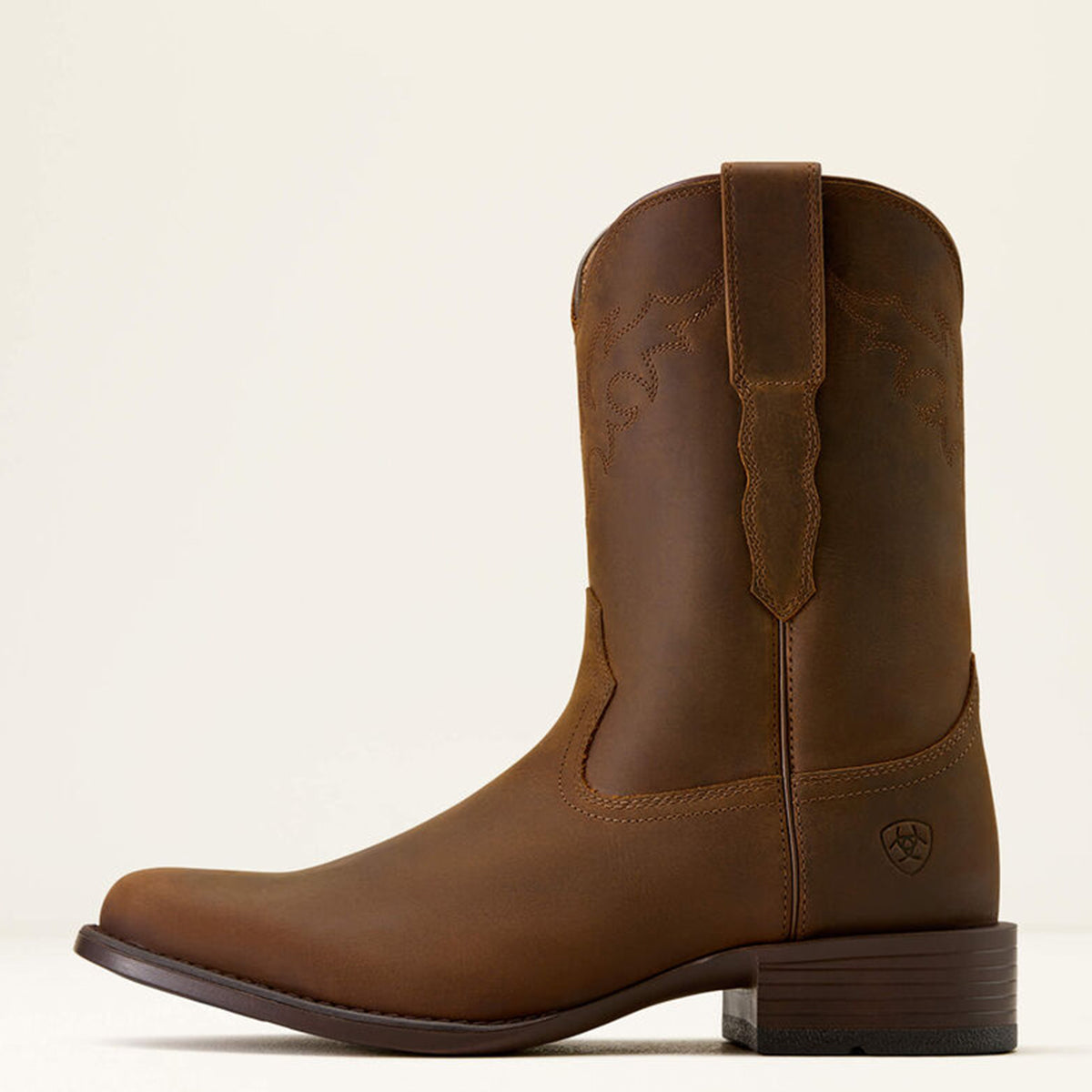 Side view of Ariat Sonoro brown leather western boot on a beige background.