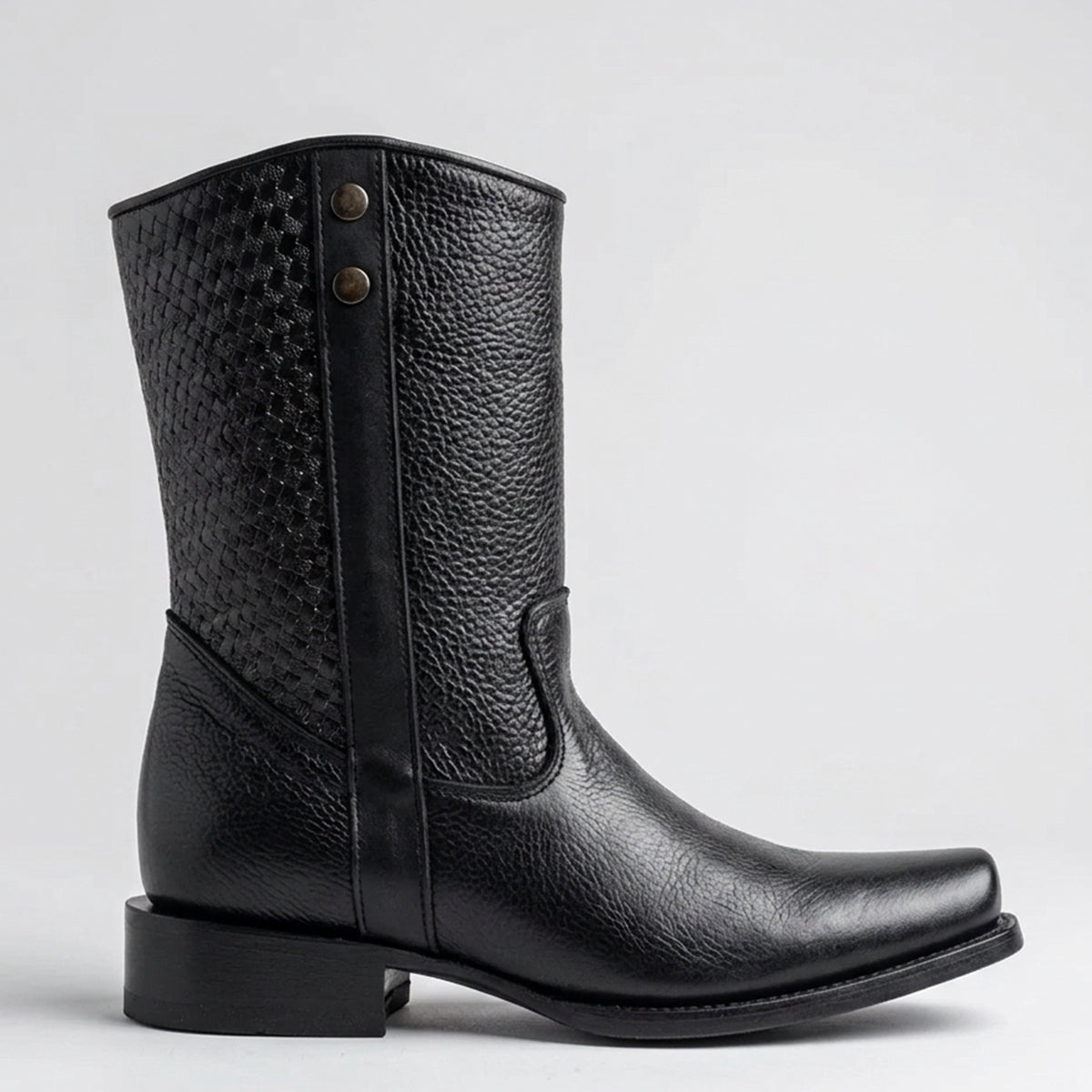 A single black leather mid-calf boot with a textured woven shaft, a square toe, and a low block heel, shown in profile against a light gray background.
