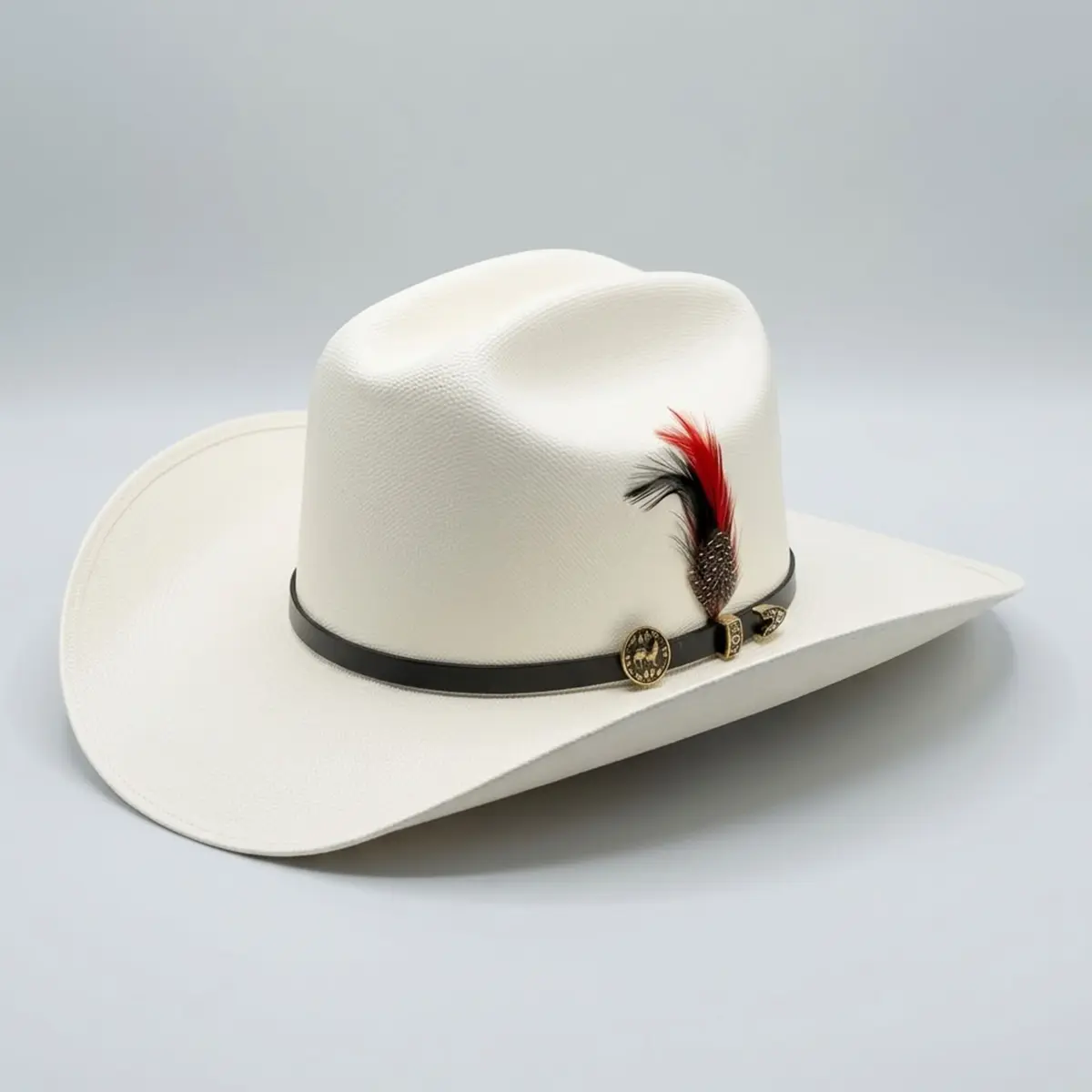 Angled studio view of the Abolengo El Gallo 1000X Chaparral straw cowboy hat displaying the fine off-white weave, black hatband, gold rooster pin, and red and black feather accent.