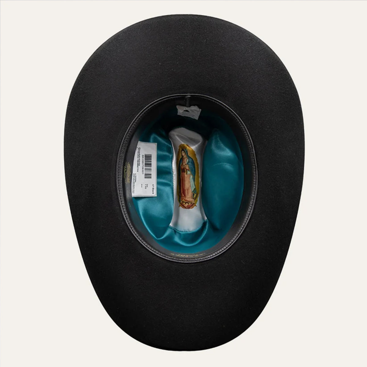 Top-down interior view of the Stetson 6X Guadalupana cowboy hat displaying the turquoise satin liner printed with the Virgin of Guadalupe image and black leather sweatband.