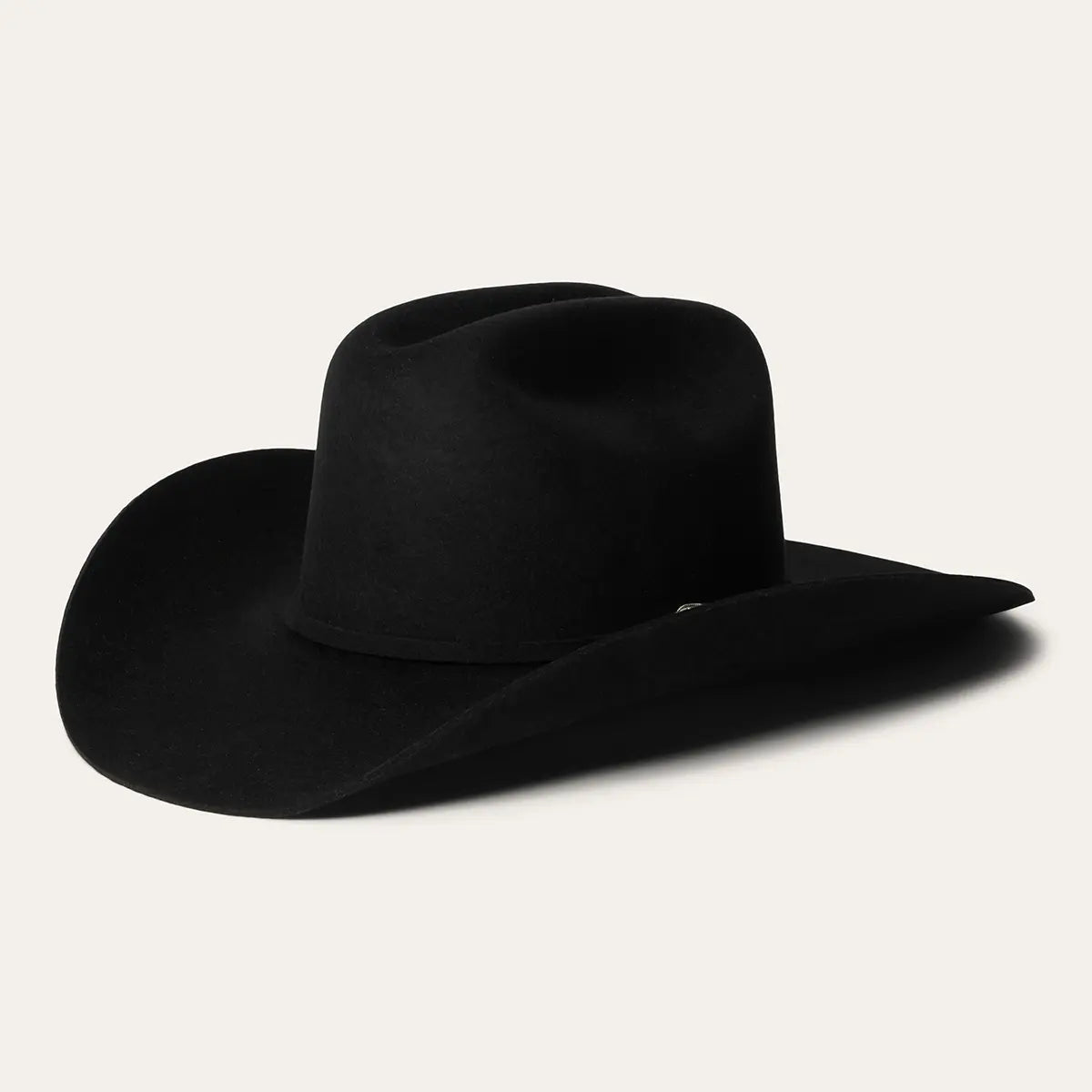 Angled studio view of the Stetson Corral 4X black buffalo felt cowboy hat showcasing the cattleman crown crease, 4-inch brim, and self-matching hatband.