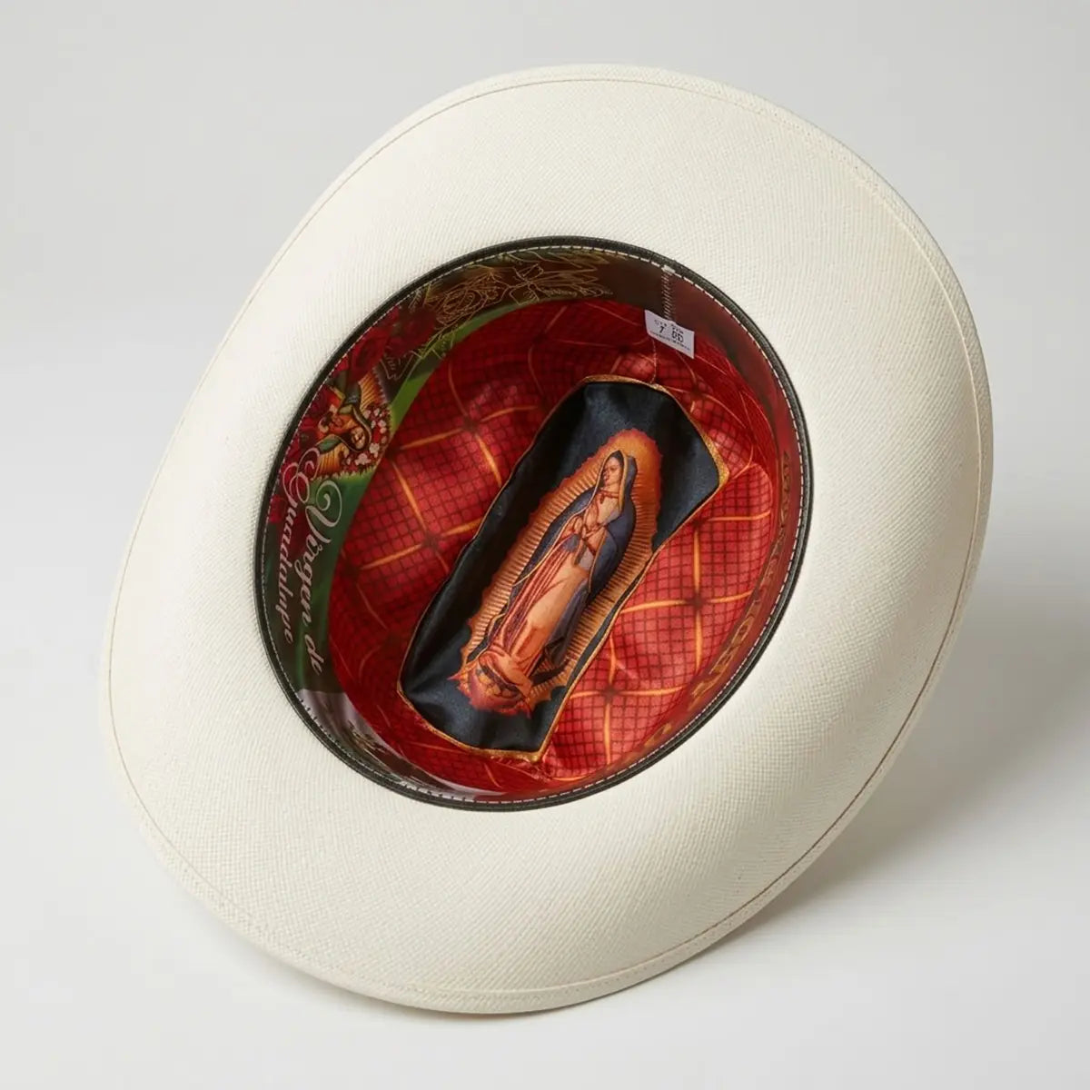 Interior studio view of the Abolengo 1000X straw cowboy hat revealing the custom silk-style crown lining with the printed Virgen de Guadalupe image and sweatband.