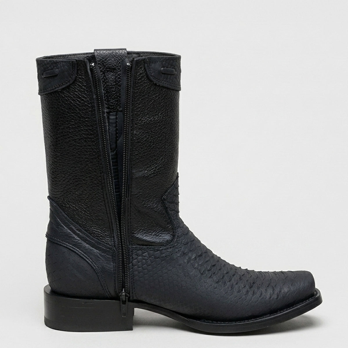 A single black leather cowboy boot with a side zipper, featuring a textured shaft and a snakeskin-patterned foot, shown against a light gray background.