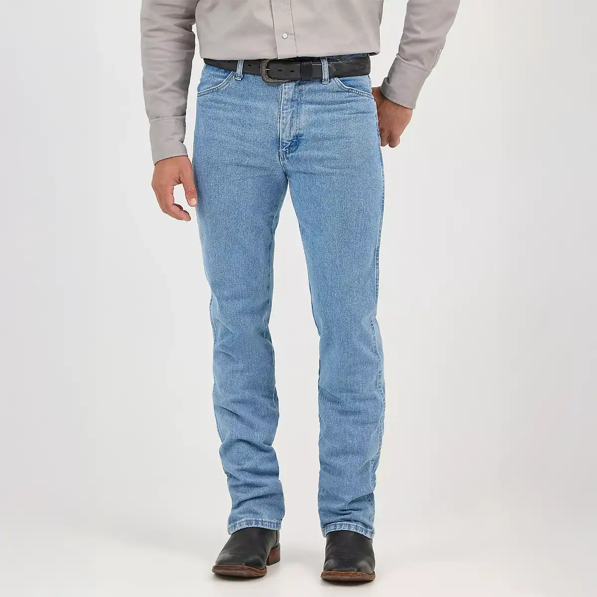 Front close-up view of a man wearing Wrangler Men's Cowboy Cut 0936 slim fit jeans in antique wash with a black leather belt.