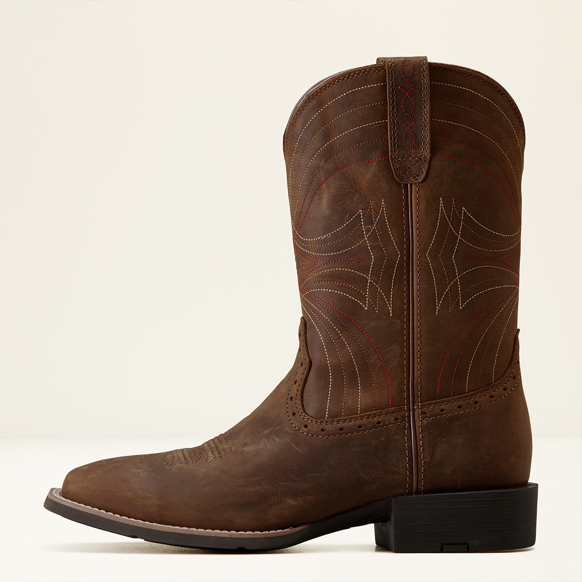 A single brown leather Ariat cowboy boot with western stitching and a dark block heel, shown in side profile against a plain light background.