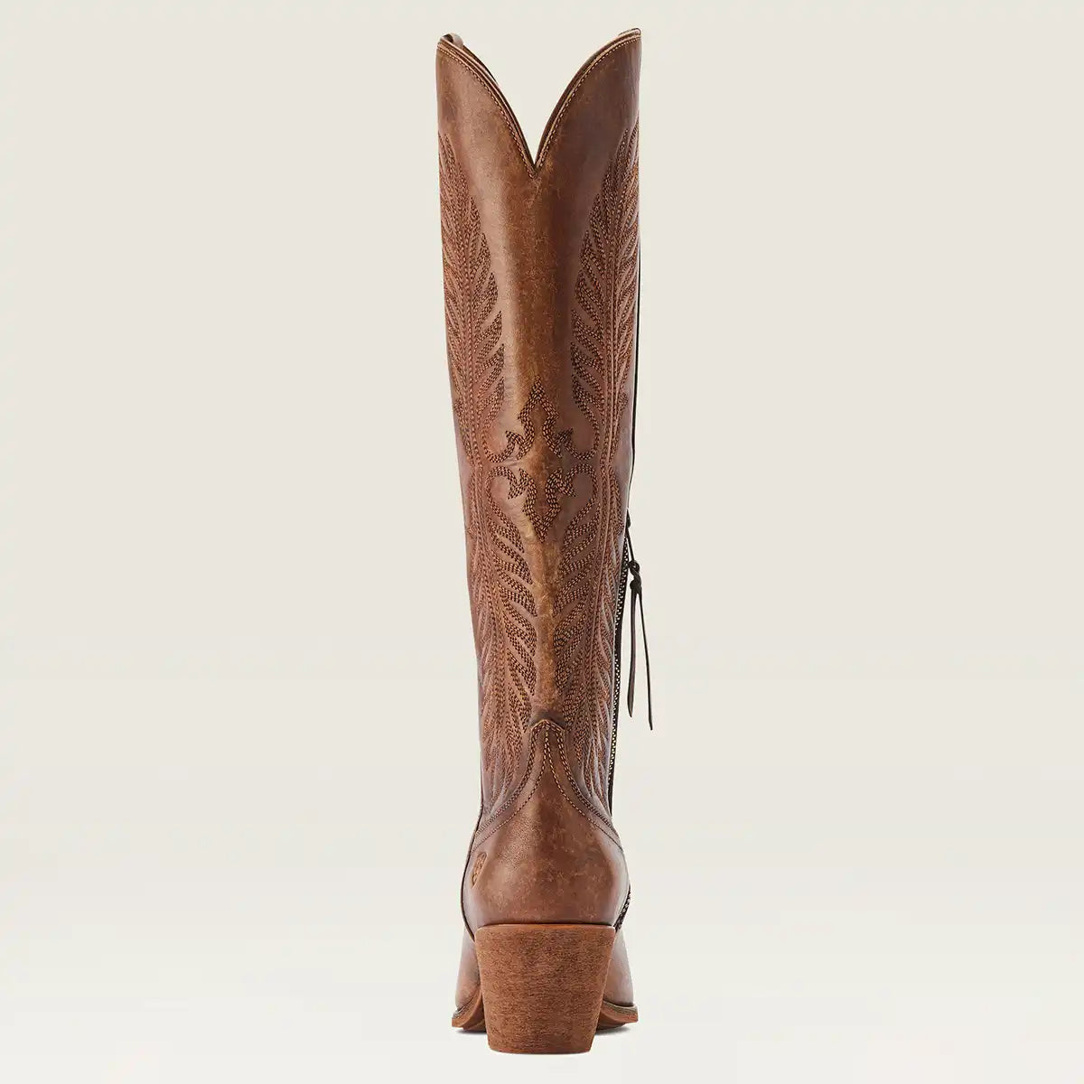 A single women's brown leather cowboy boot shown from the back, featuring decorative hand-tooled stitching and a side zipper, set against a solid off-white background.