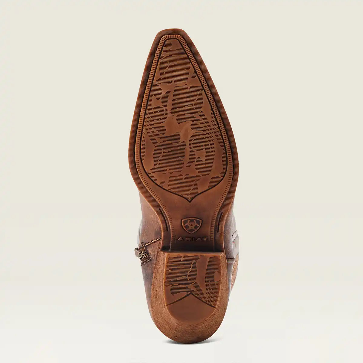A single brown leather cowboy boot shown from the sole view, featuring detailed floral tooling on the outsole and heel, with the Ariat logo visible on the insole, set against a clean off-white background.