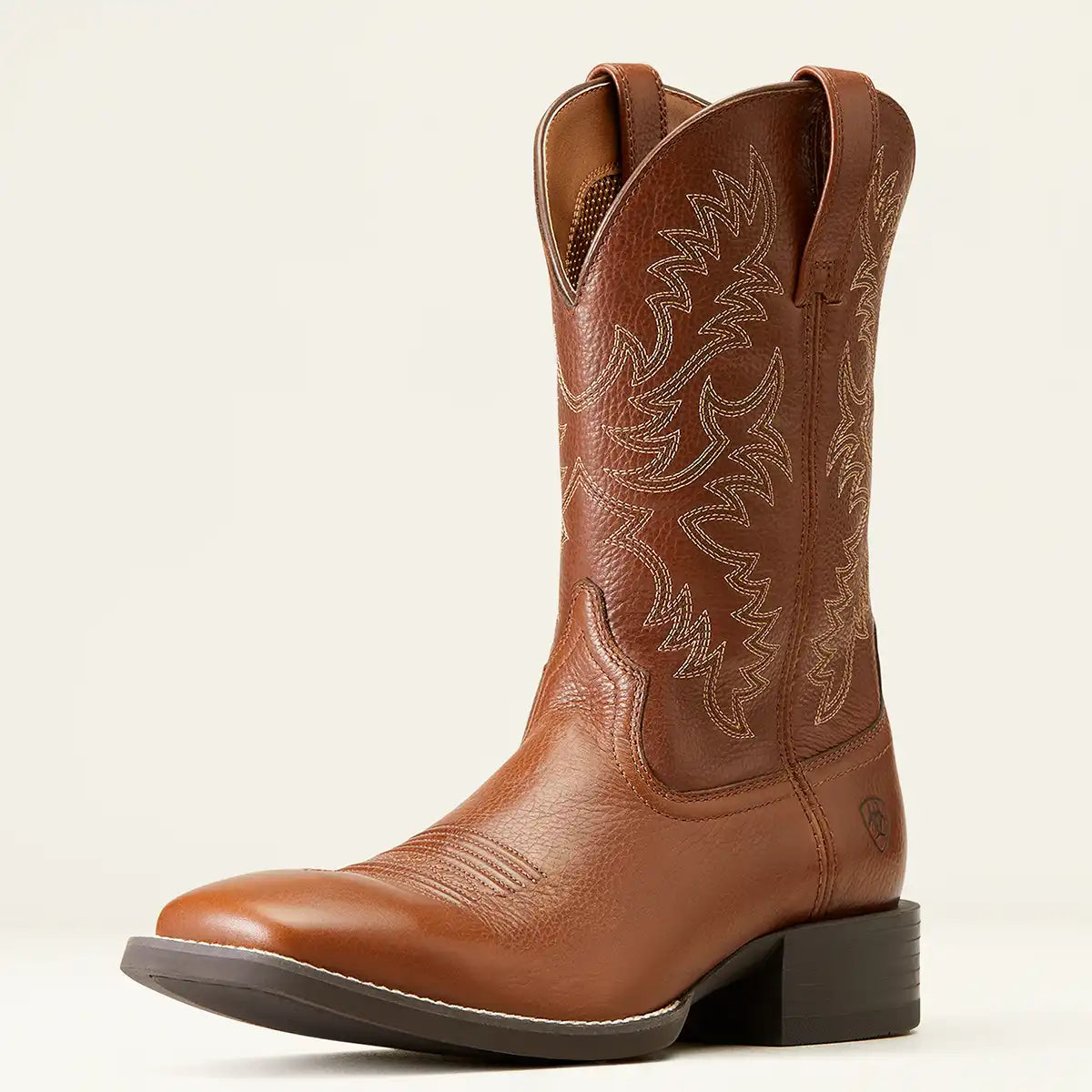 A single brown leather Ariat square toe cowboy boot with decorative western embroidery on the shaft, shown in a side profile against a light cream background.