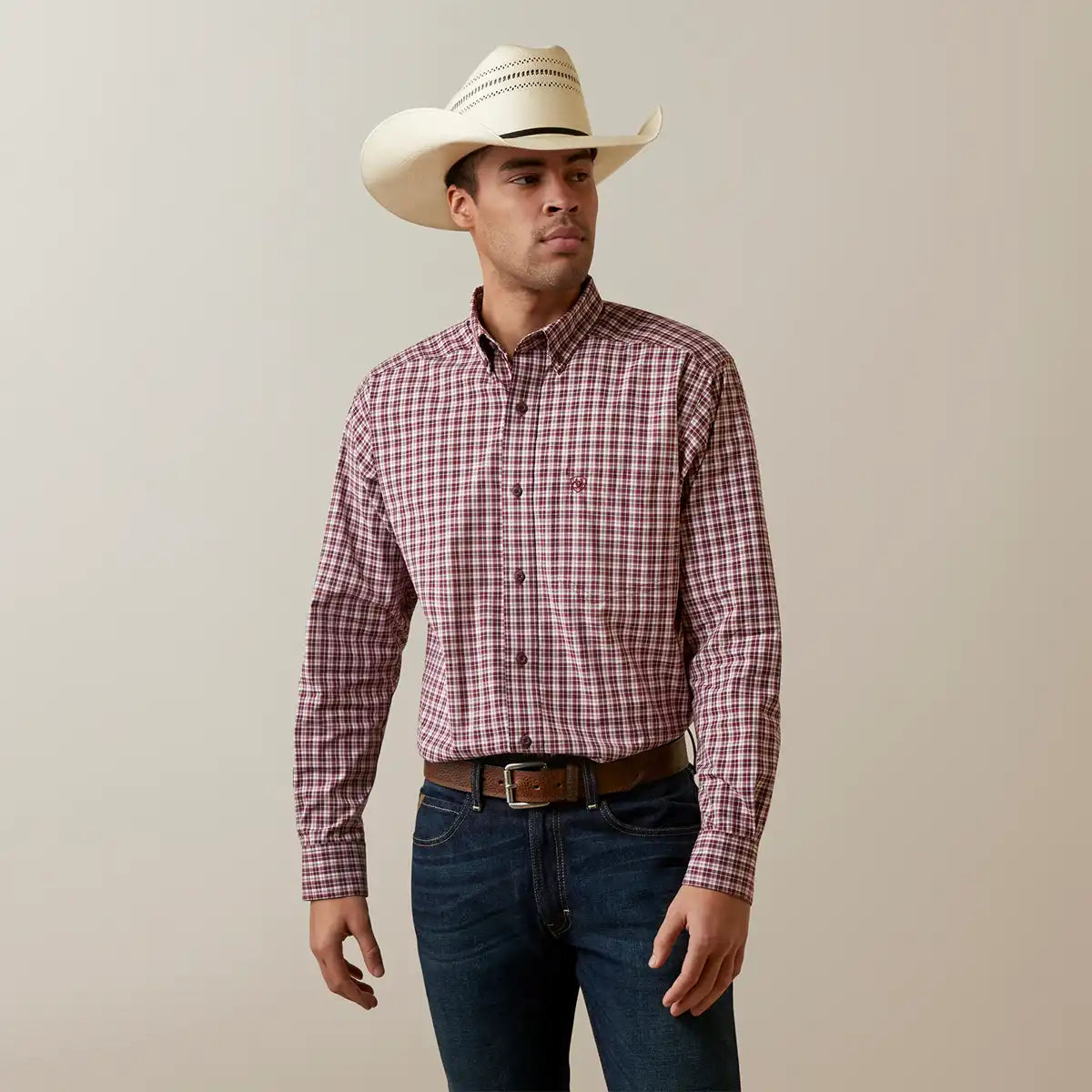 Front view of a man wearing the Ariat Men's Pro Series Archie maroon and white plaid long sleeve button-down shirt.