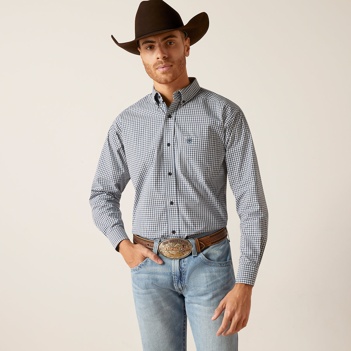 Front views of a man wearing the Ariat Men's Pro Series Garmin blue and white micro-check long sleeve button-down shirt with hat and belt.
