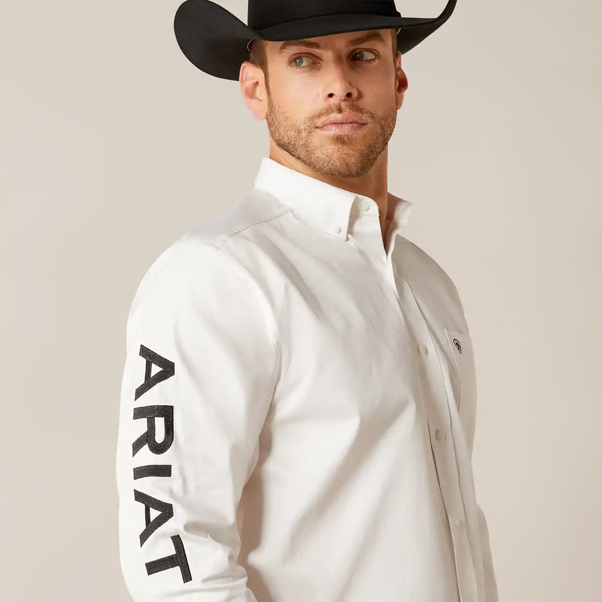 Close-up shot highlighting the bold black ARIAT text embroidery running down the right sleeve.