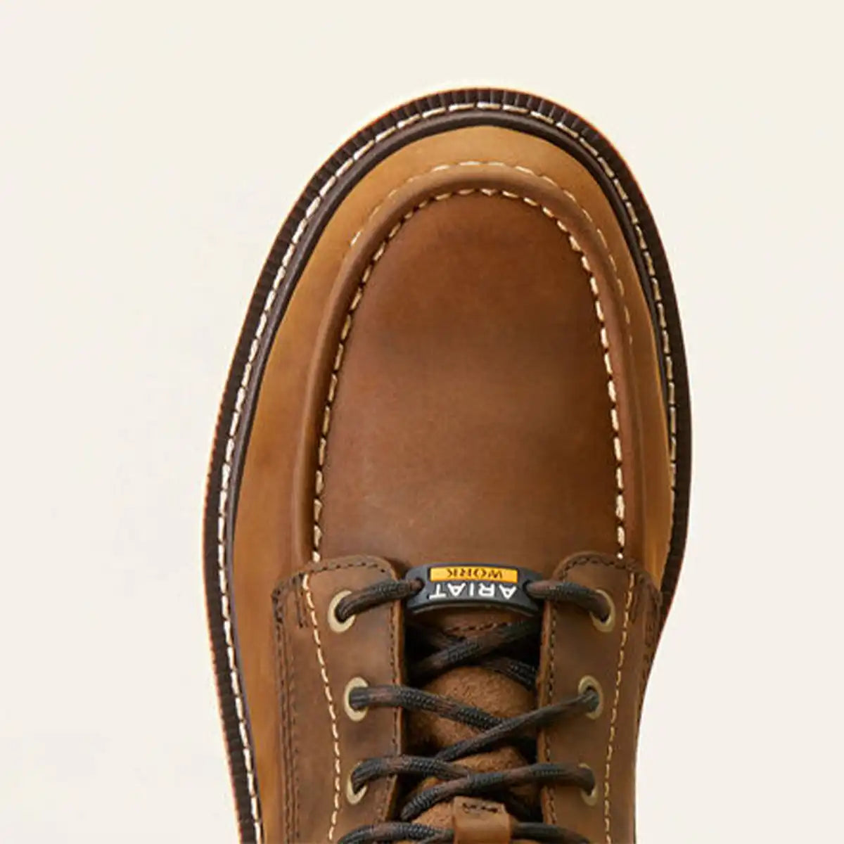 Top-down close-up view of the round moc toe stitching, non-metallic composite toe box, and speed lacing system of the Ariat Rebar Lift boot.