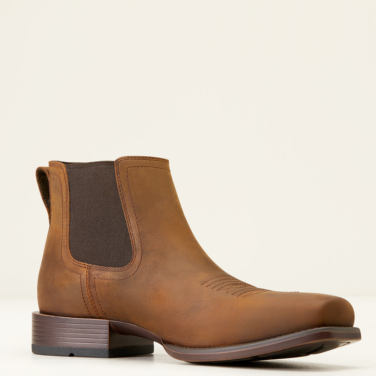 Ariat Men’s Booker Ultra Chelsea square toe boot in brown full-grain leather featuring side elastic panels, traditional toe stitching, and a horseman heel.