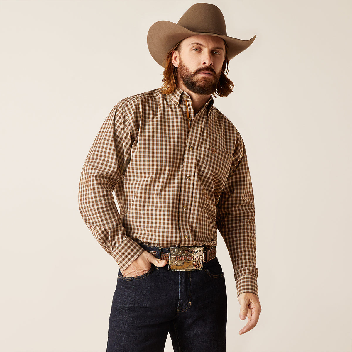 Front view of a man wearing the Ariat Men's Pro Series Ellison Horse Chestnut brown check long sleeve button-down shirt with hat and belt.