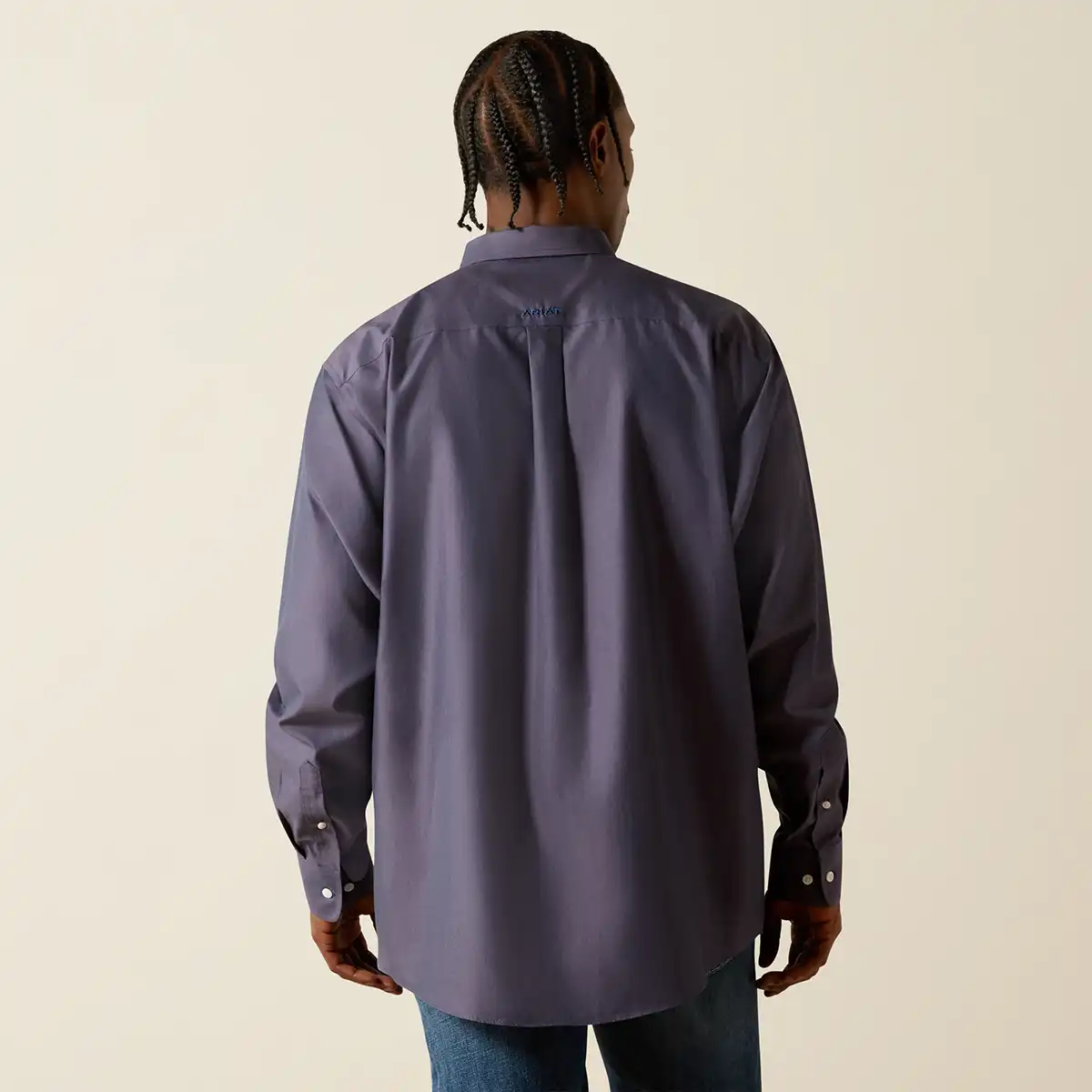 Person wearing a gray Ariat shirt on a white background.