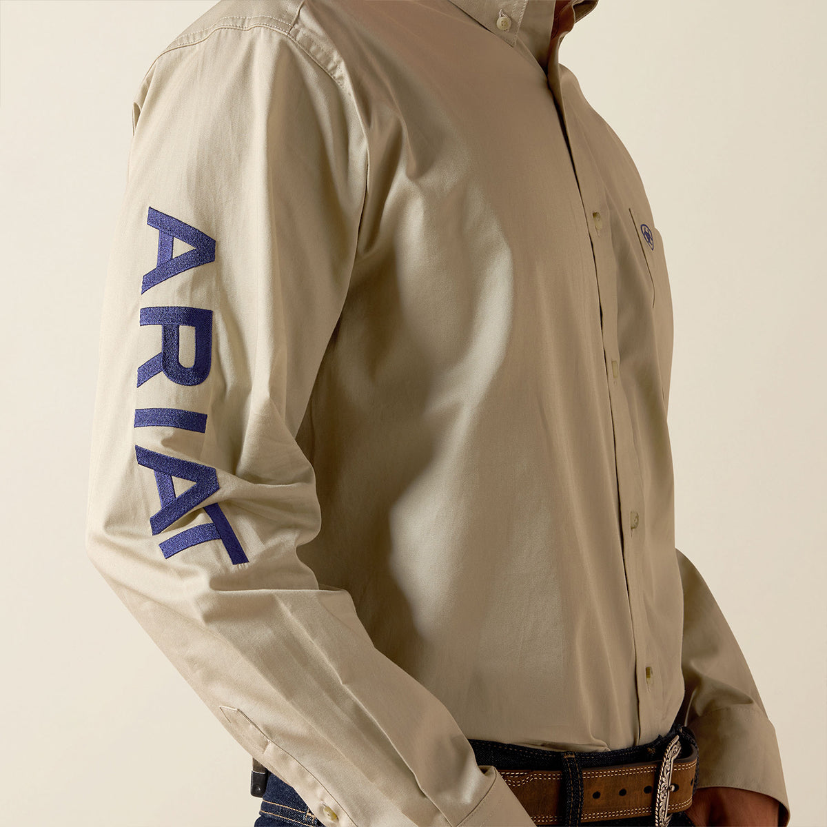 Beige jacket with 'ARIAT' branding on a neutral background.