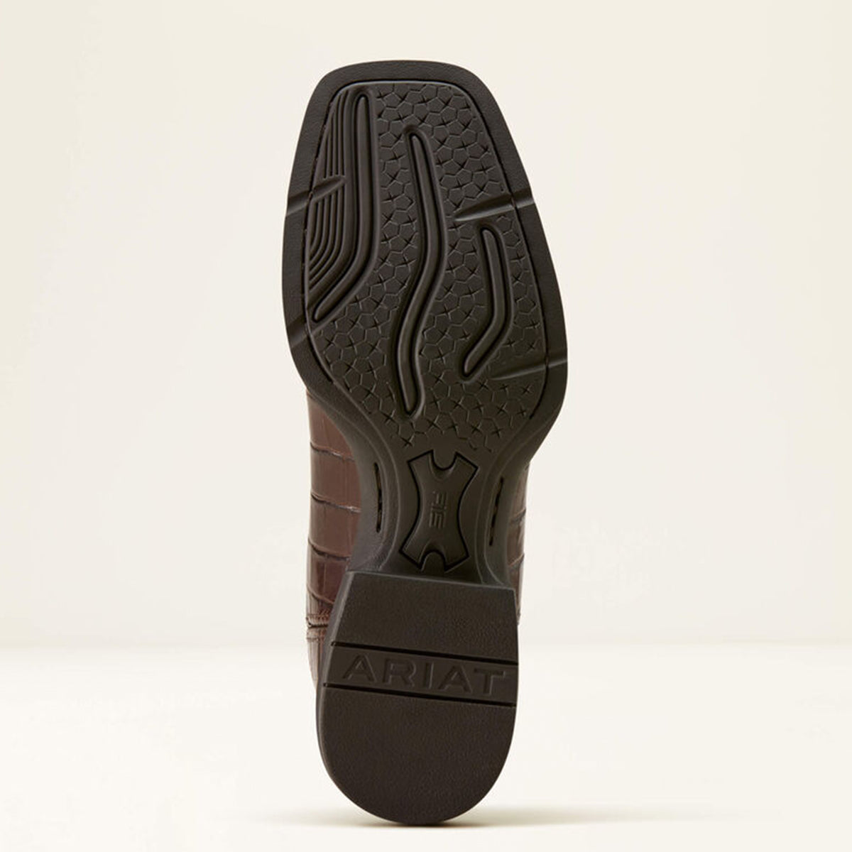 Close-up of a sole with 'Ariat' branding on a beige background.
