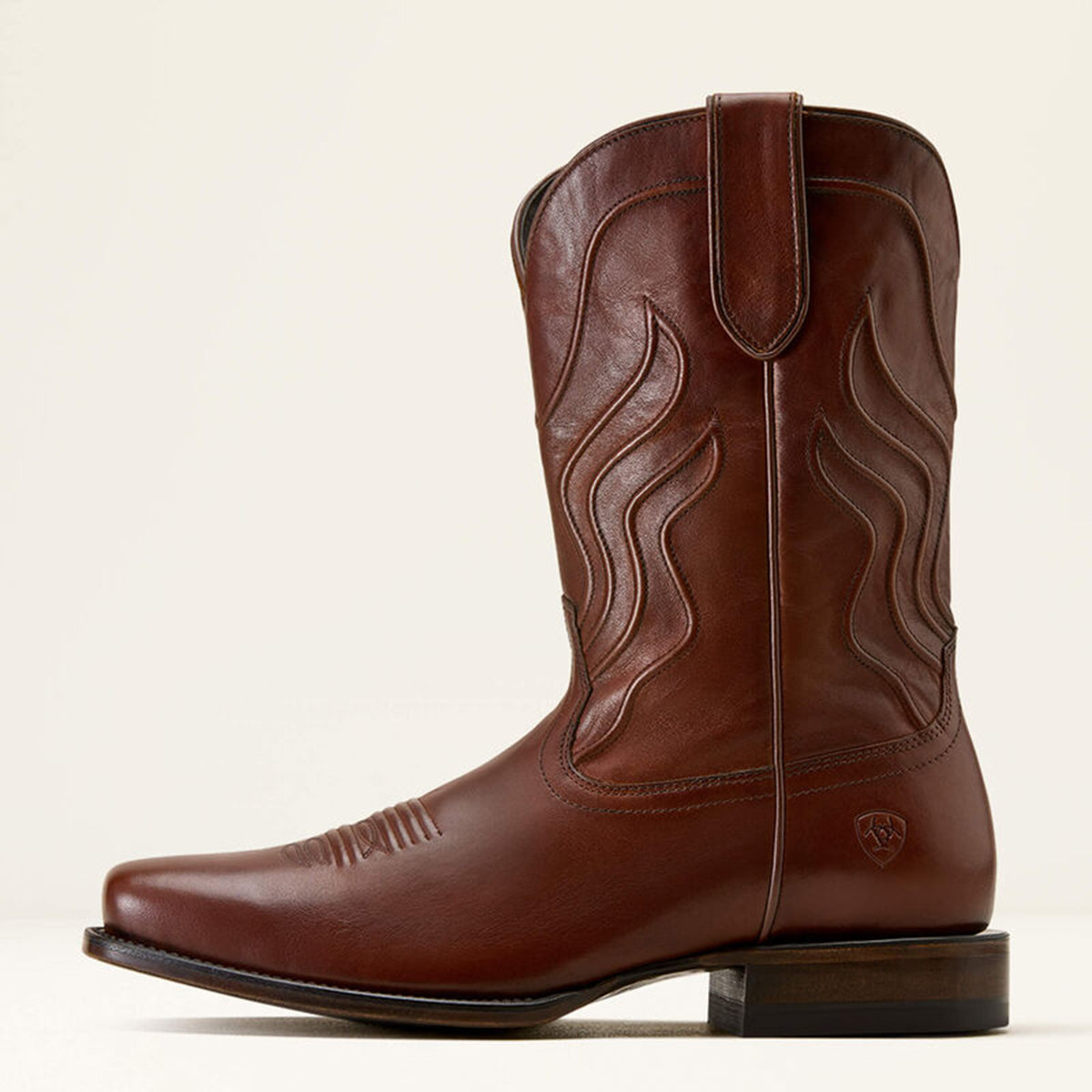 Side profile of Ariat Ridge men's brown leather square toe cowboy boot on a beige background.