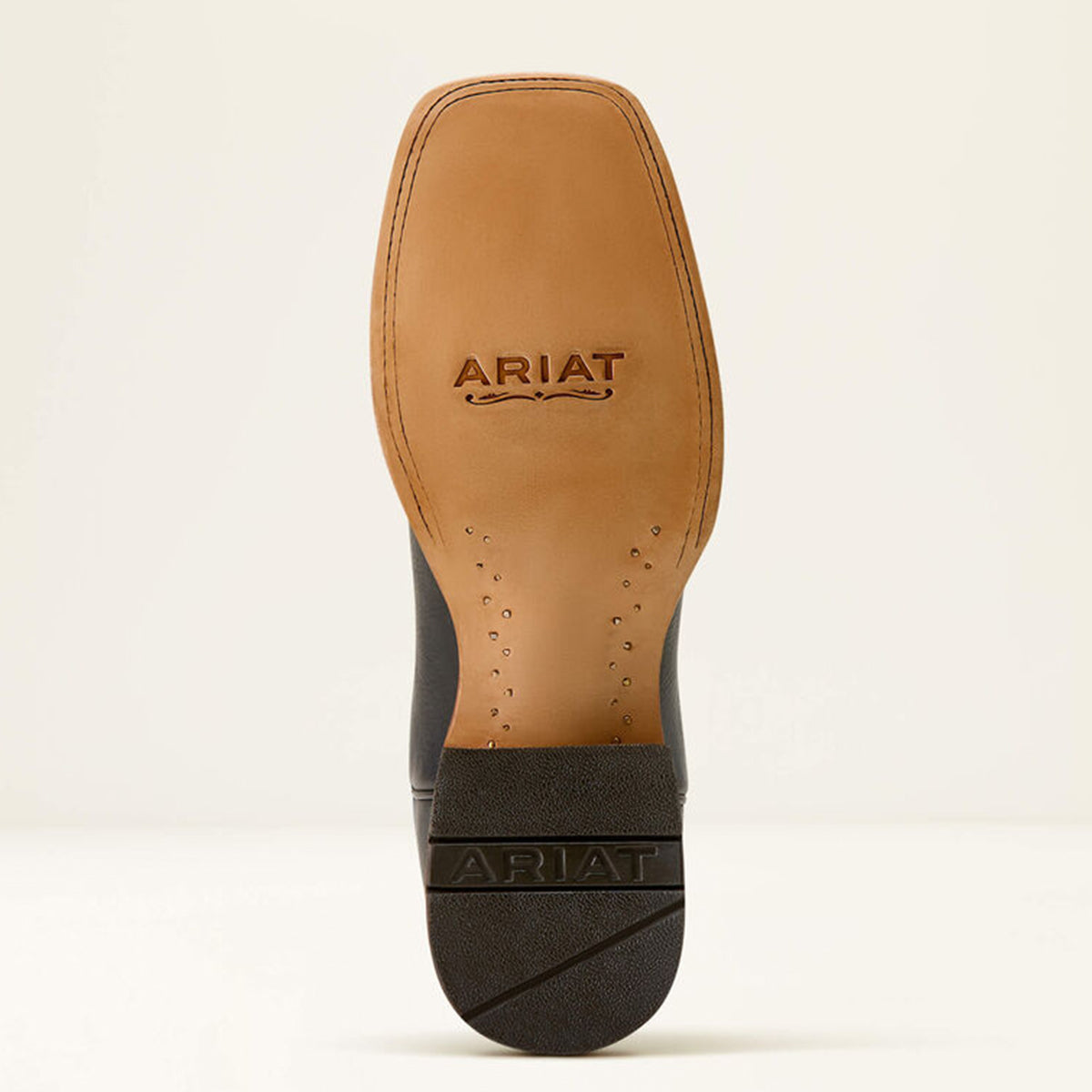 Close-up of Ariat logo on the leather sole of a boot.