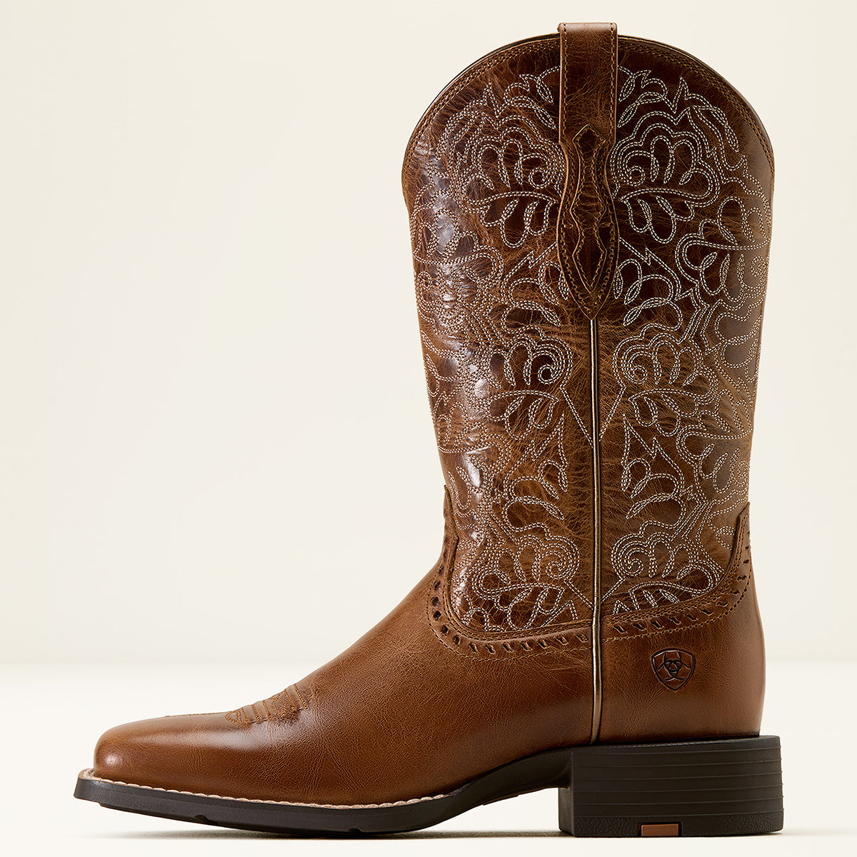 Ariat women's brown leather square toe cowgirl boot with intricate floral embroidery on the shaft, a square toe, and a dark stacked heel, photographed against a clean off-white background.