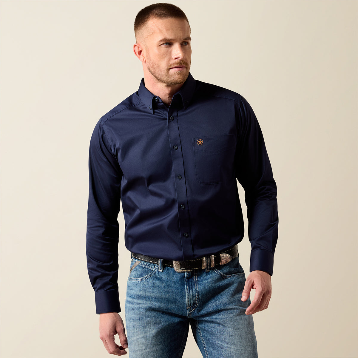 Front views of a man wearing the Ariat Men's Solid Twill long sleeve button-down shirt in Navy blue.
