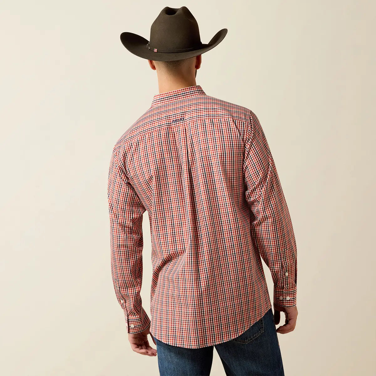 Rear studio view of a male model wearing the Ariat Men's Walter Ketchup small check shirt with a dark brown cowboy hat displaying the back yoke logo.