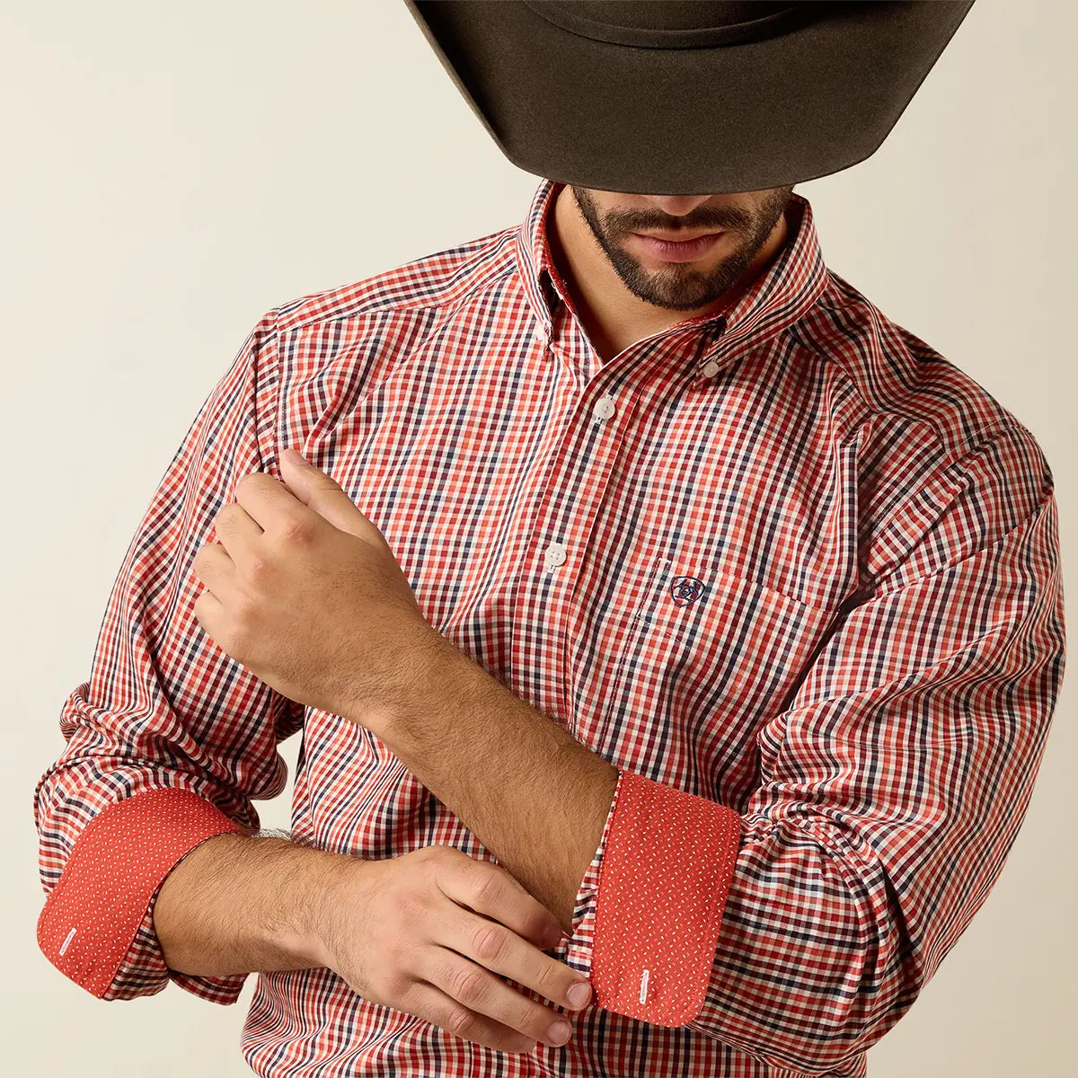 Close-up detail view of the sleeve cuffs on the Ariat Ketchup shirt rolled back to reveal the contrast red micro-dot lining.