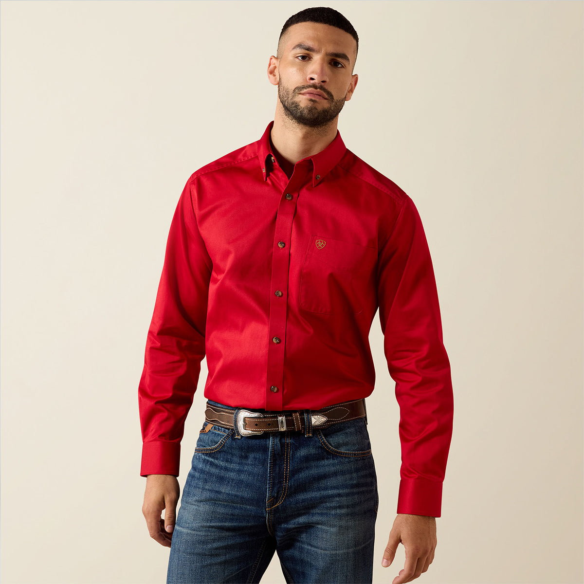 Front views of a man wearing the Ariat Men's Solid Twill long sleeve button-down shirt in vivid Scarlet red with embroidered logos.