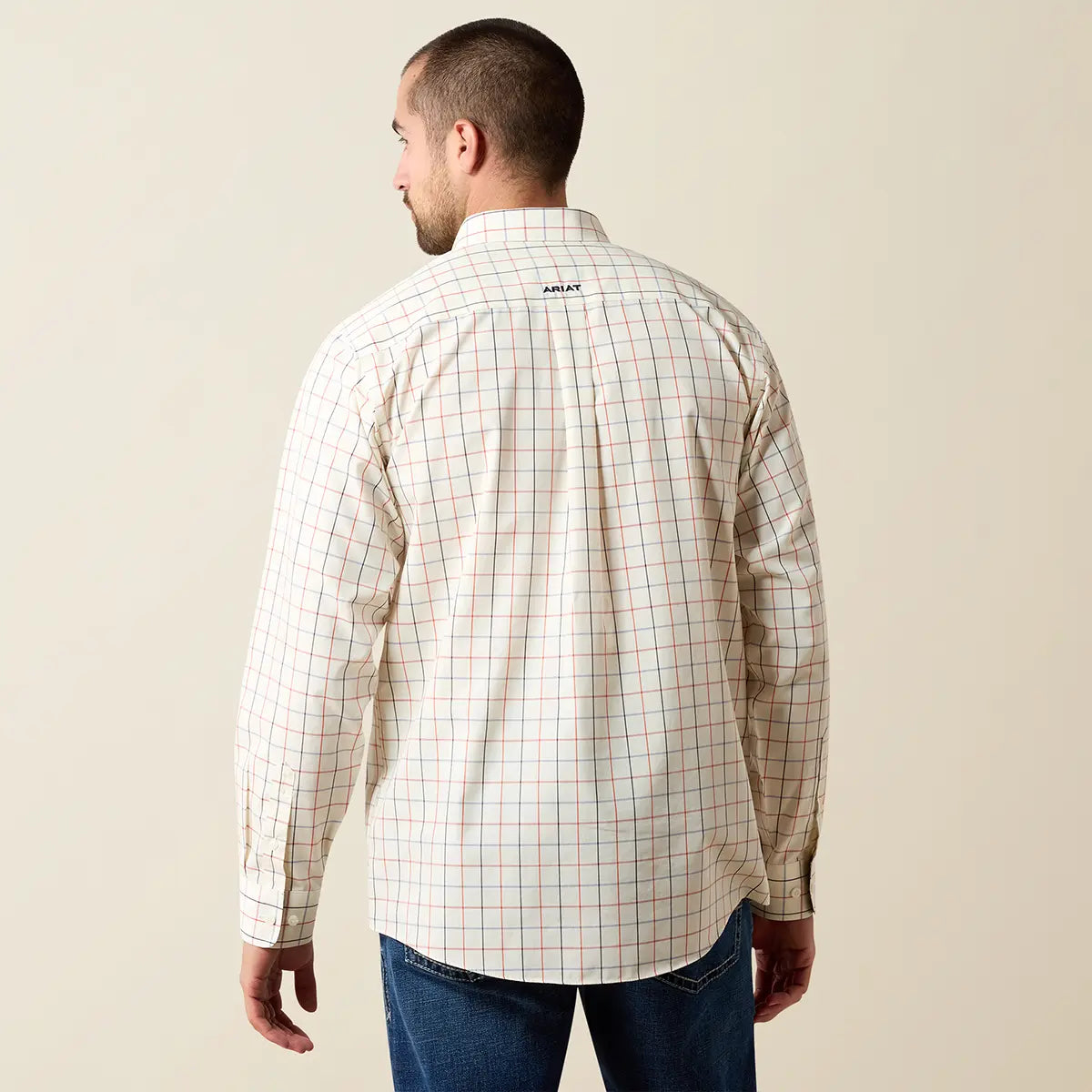 Rear studio view of a male model wearing the Ariat Men's Arctic Wolf windowpane plaid shirt displaying the Ariat logo embroidered on the back yoke.