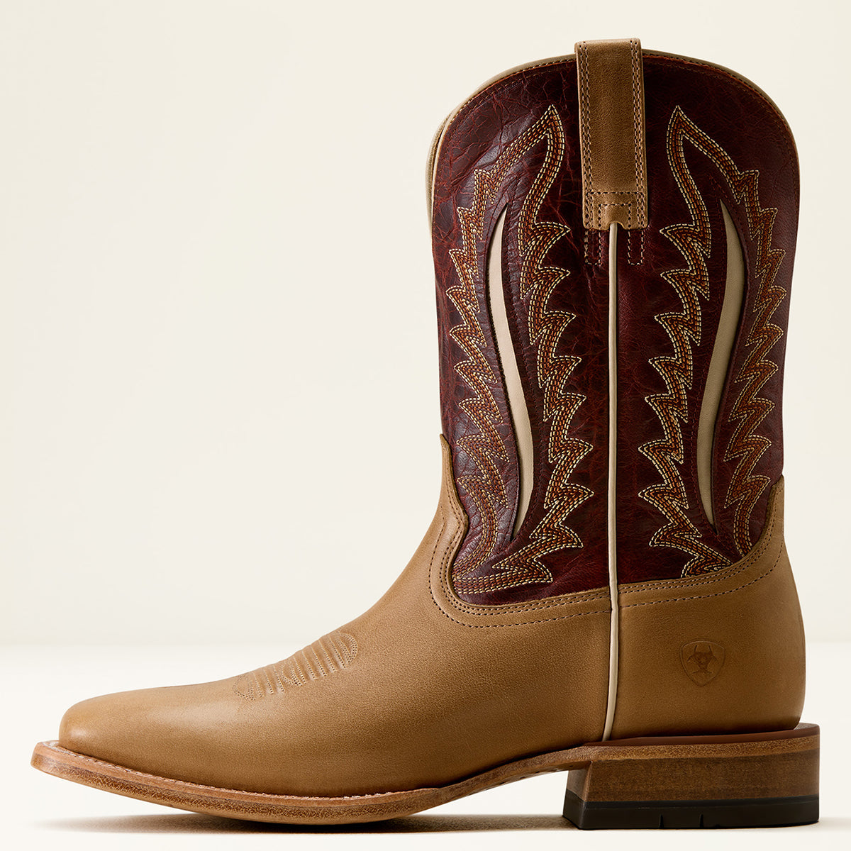 Ariat men's western cowboy boot in tan leather with a dark burgundy shaft featuring light tan embroidered stitching, shown against a plain off-white background.