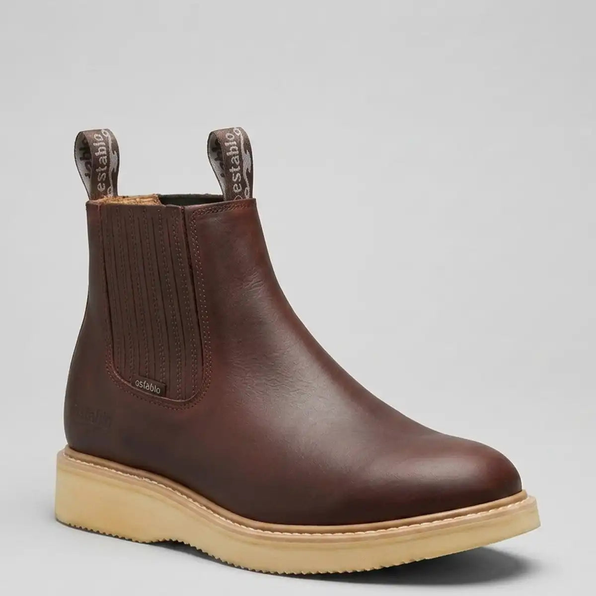 Studio profile view of the Establo Men's  brown leather pull-on work boot with cream wedge sole.