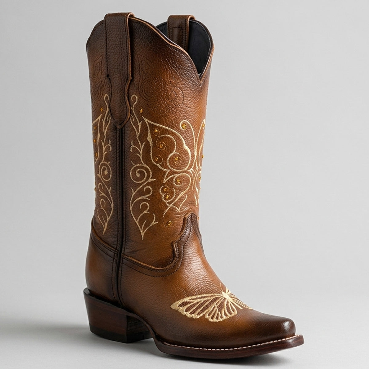 Women's warm honey brown leather snip toe cowgirl boot featuring embroidered butterfly motifs with rhinestone details.
