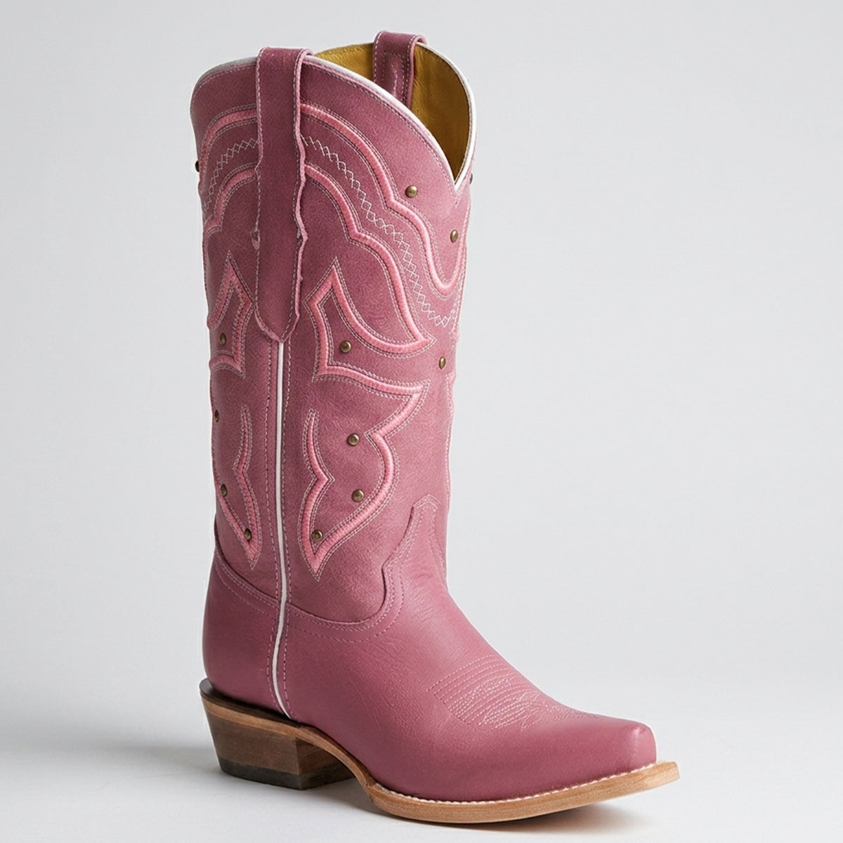 Women's pink cowboy boot with detailed stitching on a light gray background.
